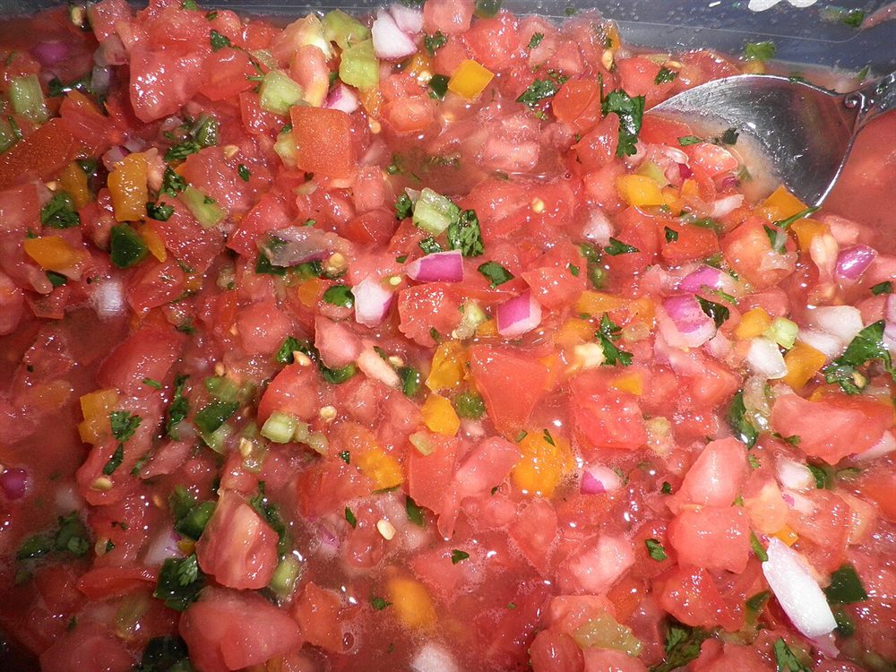 Chunky fresh red fusion salsa with tomato, onion, cilantro and peppers